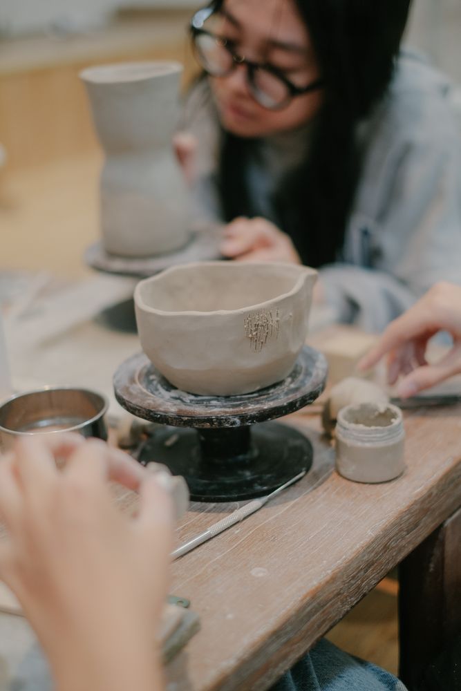 Stock photograph of hands shaping clay in a pottery class